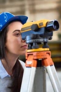 Woman looking into theodolite NLC Prep